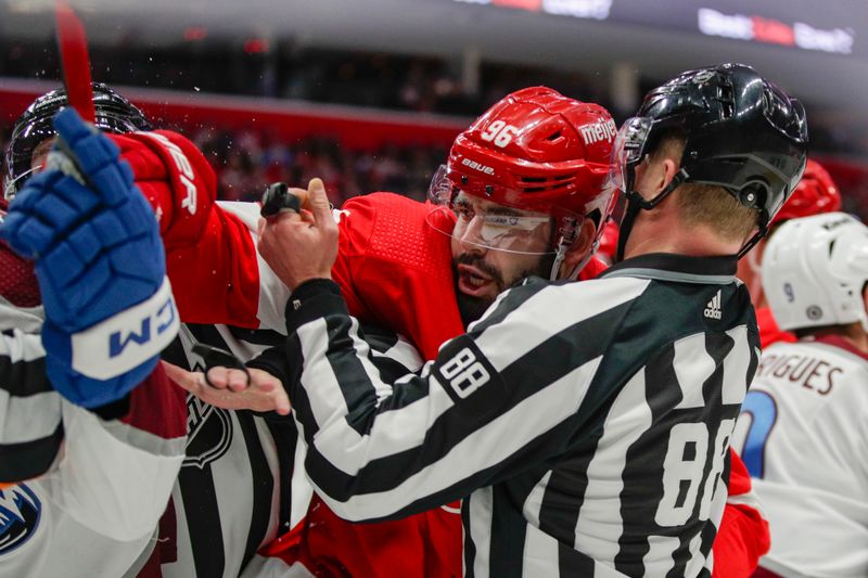 Mar 18, 2023; Detroit, Michigan, USA; Detroit Red Wings defenseman Jake Walman (96) is held back by linesman Tyson Baker (88) during the first period at Little Caesars Arena. Mandatory Credit: Brian Bradshaw Sevald-USA TODAY Sports