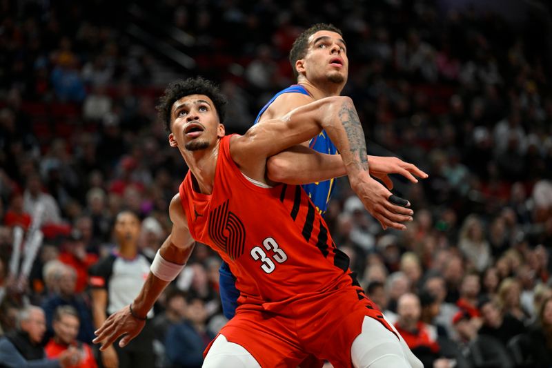 PORTLAND, OREGON - MARCH 23: Toumani Camara #33 of the Portland Trail Blazers and Michael Porter Jr. #1 of the Denver Nuggets in action during the second quarter of the game at the Moda Center on March 23, 2024 in Portland, Oregon. NOTE TO USER: User expressly acknowledges and agrees that, by downloading and or using this photograph, User is consenting to the terms and conditions of the Getty Images License Agreement. (Photo by Alika Jenner/Getty Images)