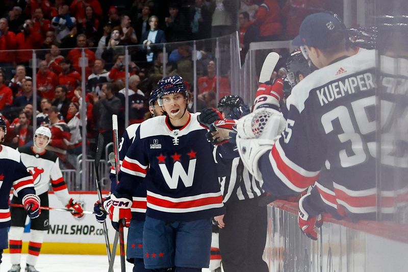 Feb 20, 2024; Washington, District of Columbia, USA; Washington Capitals center Dylan Strome (17) celebrates with teammates after scoring a goal against the New Jersey Devils in the third period at Capital One Arena. Mandatory Credit: Geoff Burke-USA TODAY Sports