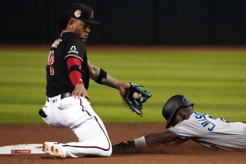 May 9, 2023; Phoenix, Arizona, USA; Miami Marlins center fielder Jazz Chisholm Jr. (2) slides into second base safely for a steal ahead of a throw to Arizona Diamondbacks second baseman Ketel Marte (4) during the fifth inning at Chase Field. Mandatory Credit: Joe Camporeale-USA TODAY Sports