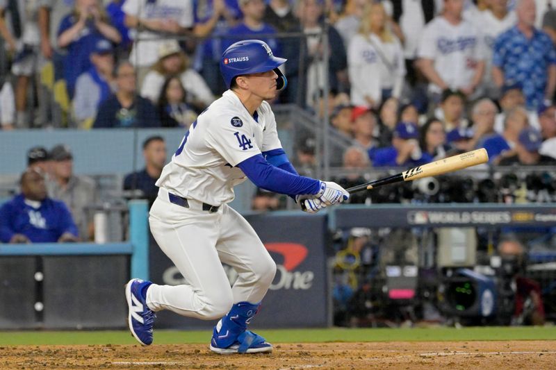 Oct 26, 2024; Los Angeles, California, USA; Los Angeles Dodgers shortstop Tommy Edman (25) hits a double in the third inning against the New York Yankees during game two of the 2024 MLB World Series at Dodger Stadium. Mandatory Credit: Jayne Kamin-Oncea-Imagn Images