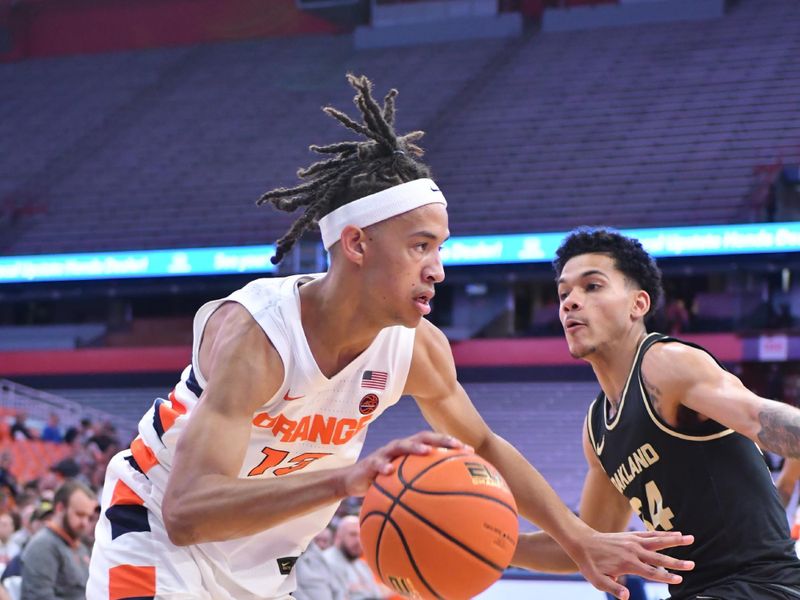 Dec 6, 2022; Syracuse, New York, USA; Syracuse Orange forward Benny Williams (13) drives past Oakland Golden Grizzlies guard Jalen Moore (34) in the first half at JMA Wireless Dome. Mandatory Credit: Mark Konezny-USA TODAY Sports