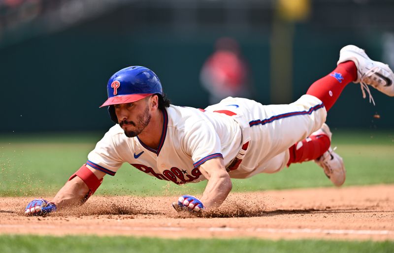 Aug 30, 2023; Philadelphia, Pennsylvania, USA; Philadelphia Phillies catcher Garrett Stubbs (21) dives back to first after hitting a single against the Los Angeles Angels in the fourth inning at Citizens Bank Park. Mandatory Credit: Kyle Ross-USA TODAY Sports