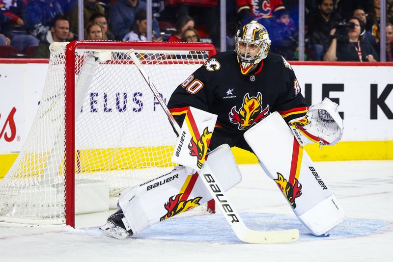 Oct 24, 2024; Calgary, Alberta, CAN; Calgary Flames goaltender Dan Vladar (80) guards his net against the Carolina Hurricanes during the first period at Scotiabank Saddledome. Mandatory Credit: Sergei Belski-Imagn Images