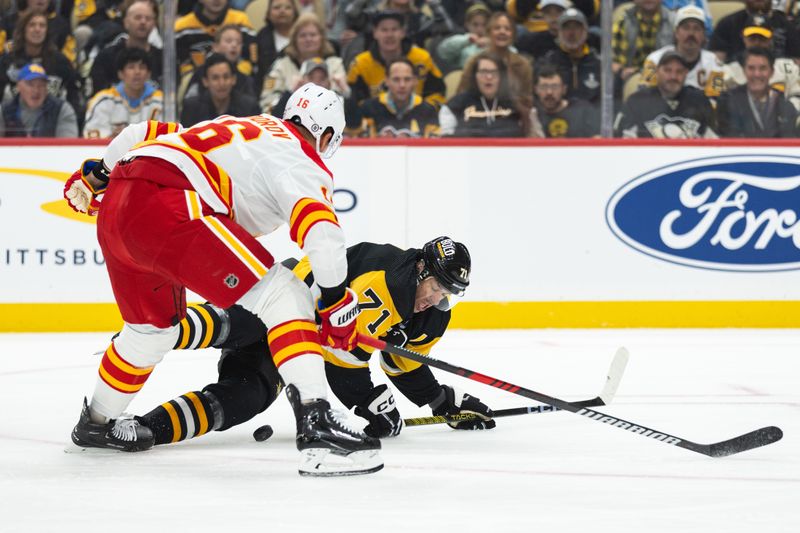 Oct 14, 2023; Pittsburgh, Pennsylvania, USA; Calgary Flames defenseman Nikita Zadorov (16) pushes Pittsburgh Penguins center Evgeni Malkin (71) to the ice as they battle for the puck during the first period at PPG Paints Arena. Mandatory Credit: Scott Galvin-USA TODAY Sports