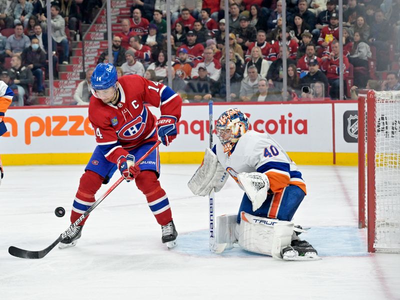 Jan 25, 2024; Montreal, Quebec, CAN; Montreal Canadiens forward Nick Suzuki (14) plays the puck in front of New York Islanders goalie Semyon Varlamov (40) during the third period at the Bell Centre. Mandatory Credit: Eric Bolte-USA TODAY Sports