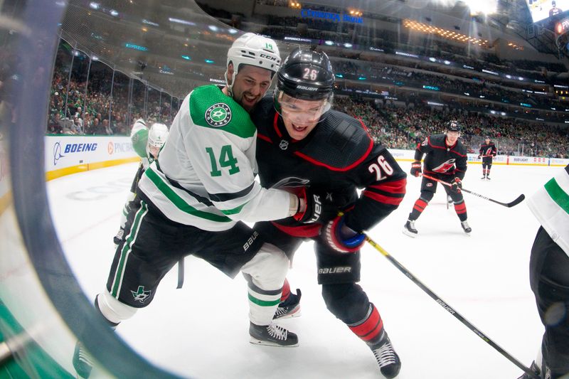 Jan 25, 2023; Dallas, Texas, USA; Dallas Stars left wing Jamie Benn (14) and Carolina Hurricanes center Paul Stastny (26) battle for control of the puck in the Stars zone during the first period at the American Airlines Center. Mandatory Credit: Jerome Miron-USA TODAY Sports