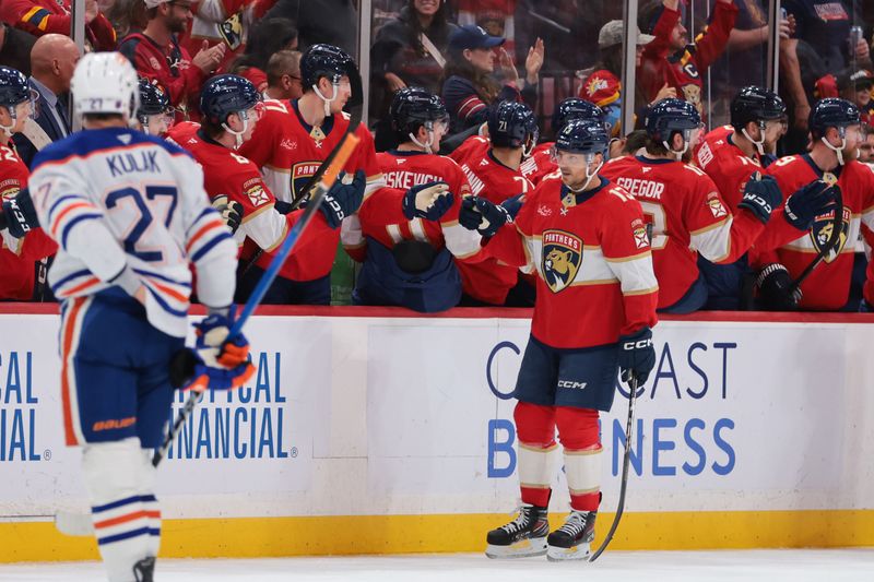 Nov 22, 2025; Sunrise, Florida, USA; Florida Panthers center Sam Reinhart (13) celebrates with teammates after scoring against the Edmonton Oilers during the second period at Amerant Bank Arena. Mandatory Credit: Sam Navarro-Imagn Images
