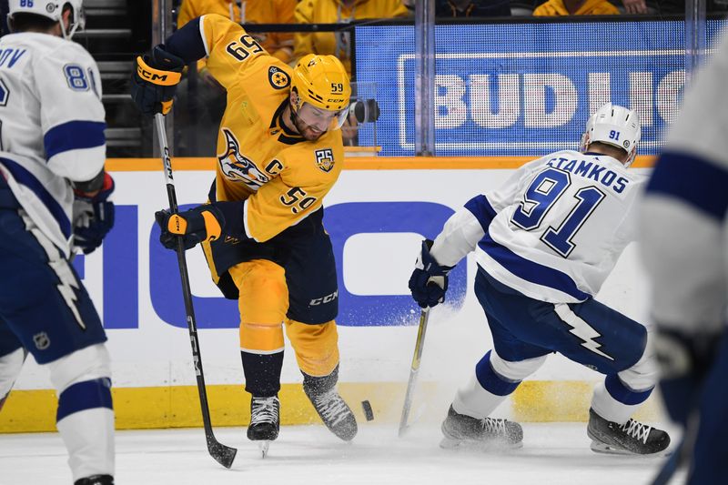 Dec 7, 2023; Nashville, Tennessee, USA; Nashville Predators defenseman Roman Josi (59) has the puck knocked away by Tampa Bay Lightning center Steven Stamkos (91) during the first period at Bridgestone Arena. Mandatory Credit: Christopher Hanewinckel-USA TODAY Sports