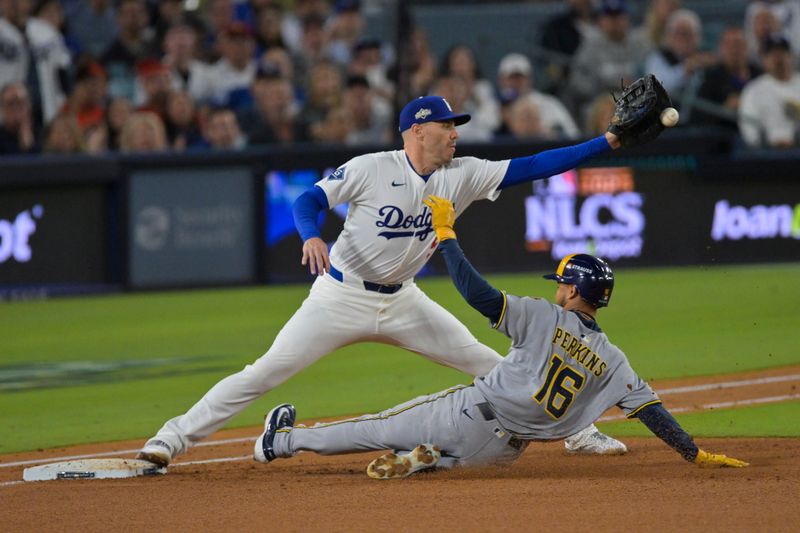 Oct 17, 2025; Los Angeles, California, USA; Los Angeles Dodgers first baseman Freddie Freeman (5) doubles off Milwaukee Brewers center fielder Blake Perkins (16) at first base during the third inning of game four of the NLCS round for the 2025 MLB playoffs at Dodger Stadium. Mandatory Credit: Jayne Kamin-Oncea-Imagn Images