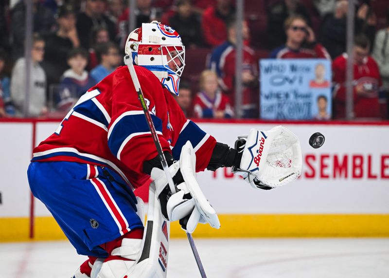 Oct 21, 2023; Montreal, Quebec, CAN; Montreal Canadiens goalie Jake Allen (34) takes shots during warm-up before the game against the Washington Capitals at Bell Centre. Mandatory Credit: David Kirouac-USA TODAY Sports