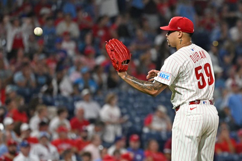 Sep 23, 2025; Philadelphia, Pennsylvania, USA; Philadelphia Phillies pitcher Jhoan Duran (59) gets a new baseball after allowing game-tying home run during the ninth inning against the Miami Marlins at Citizens Bank Park. Mandatory Credit: Eric Hartline-Imagn Images