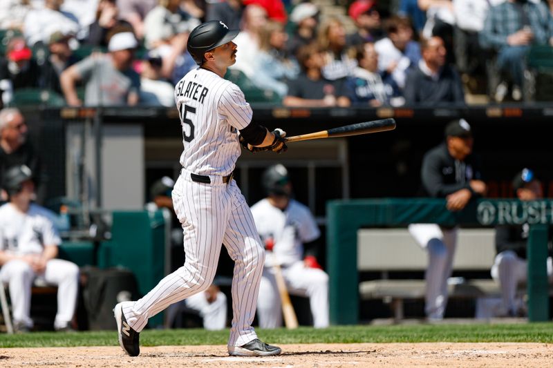 May 25, 2025; Chicago, Illinois, USA; Chicago White Sox left fielder Austin Slater (15) hits a solo home run against the Texas Rangers during the sixth inning at Rate Field. Mandatory Credit: Kamil Krzaczynski-Imagn Images