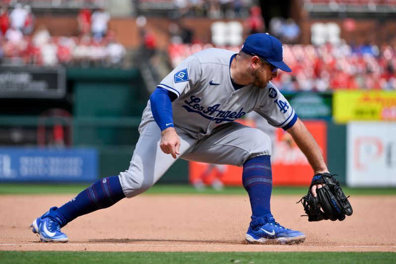 Jun 8, 2025; St. Louis, Missouri, USA;  Los Angeles Dodgers third baseman Max Muncy (13) fields a ground ball against the St. Louis Cardinals during the eighth inning at Busch Stadium. Mandatory Credit: Jeff Curry-Imagn Images