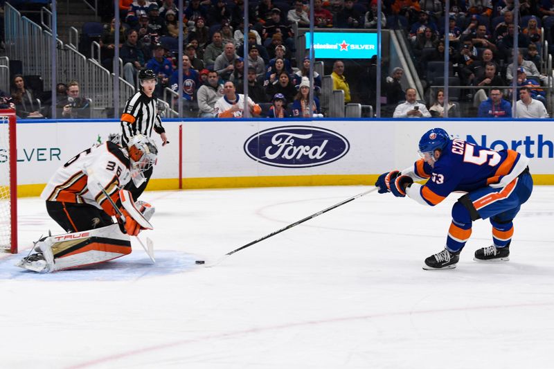 Dec 13, 2023; Elmont, New York, USA; Anaheim Ducks goaltender John Gibson (36) makes a save on New York Islanders center Casey Cizikas (53) during the second period at UBS Arena. Mandatory Credit: Dennis Schneidler-USA TODAY Sports