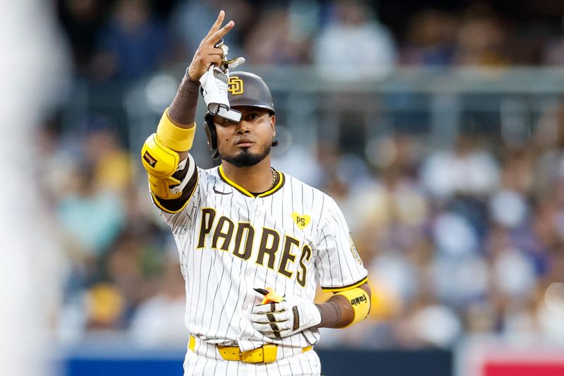 Jul 30, 2024; San Diego, California, USA; San Diego Padres designated hitter Luis Arraez (4) celebrates after hitting a double during the third inning against the Los Angeles Dodgers at Petco Park. Mandatory Credit: David Frerker-USA TODAY Sports