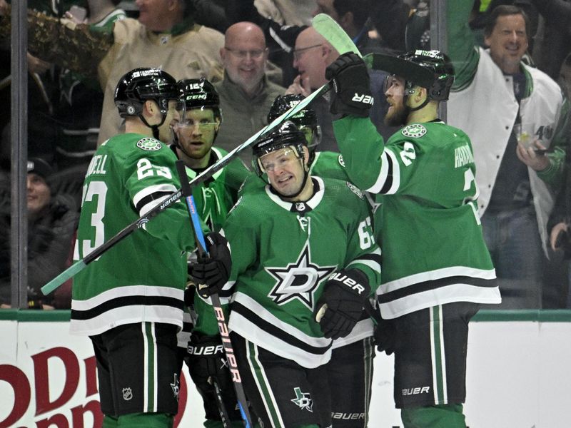 Jan 16, 2024; Dallas, Texas, USA; Dallas Stars defenseman Esa Lindell (23) and right wing Evgenii Dadonov (63) and defenseman Jani Hakanpaa (2) celebrates a goal scored by Dadonov against the Los Angeles Kings during the first period at the American Airlines Center. Mandatory Credit: Jerome Miron-USA TODAY Sports