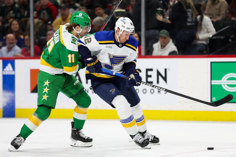 Mar 23, 2024; Saint Paul, Minnesota, USA; Minnesota Wild left wing Adam Beckman (11) and St. Louis Blues right wing Kevin Hayes (12) compete for the puck during the second period at Xcel Energy Center. Mandatory Credit: Matt Krohn-USA TODAY Sports