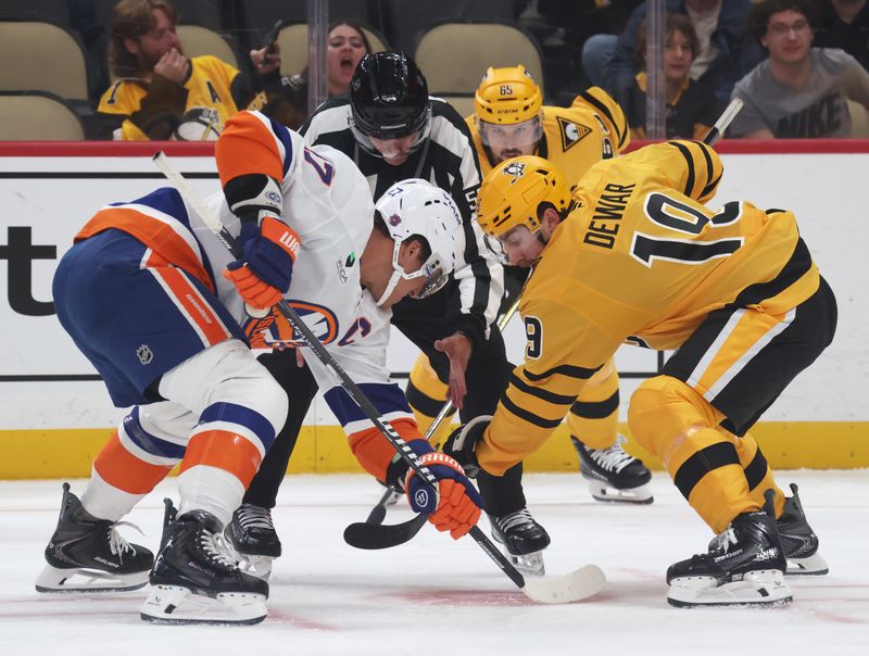 Oct 9, 2025; Pittsburgh, Pennsylvania, USA;  New York Islanders left wing Anders Lee (27) and Pittsburgh Penguins center Connor Dewar (19) take a second period face-off at PPG Paints Arena. Mandatory Credit: Charles LeClaire-Imagn Images
