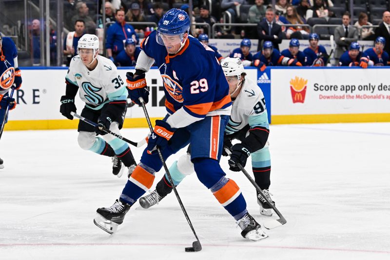 Feb 13, 2024; Elmont, New York, USA; New York Islanders center Brock Nelson (29) attempts a shot defended by Seattle Kraken left wing Andre Burakovsky (95) during the second period at UBS Arena. Mandatory Credit: Dennis Schneidler-USA TODAY Sports