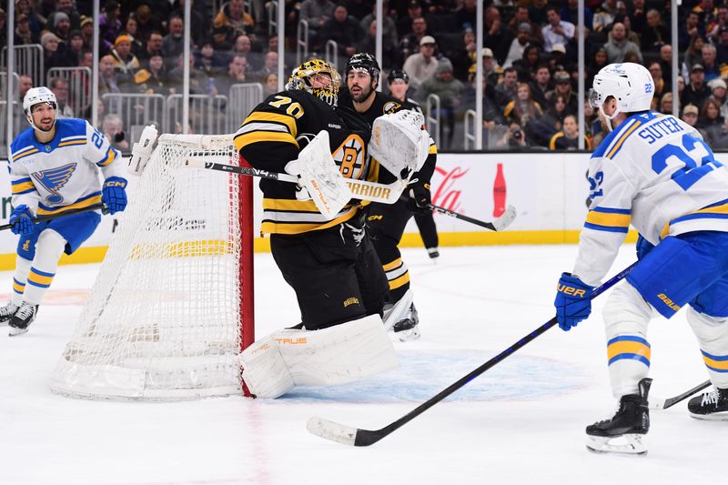 Dec 4, 2025; Boston, Massachusetts, USA; Boston Bruins goaltender Joonas Korpisalo (70) makes a save in front of St. Louis Blues center Pius Suter (22) during the second period at TD Garden. Mandatory Credit: Bob DeChiara-Imagn Images