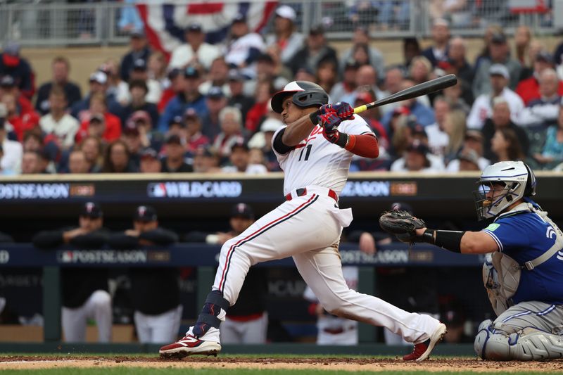 Oct 4, 2023; Minneapolis, Minnesota, USA; Minnesota Twins second baseman Jorge Polanco (11) hits a single in the fifth inning against the Toronto Blue Jays during game two of the Wildcard series for the 2023 MLB playoffs at Target Field. Mandatory Credit: Jesse Johnson-USA TODAY Sports