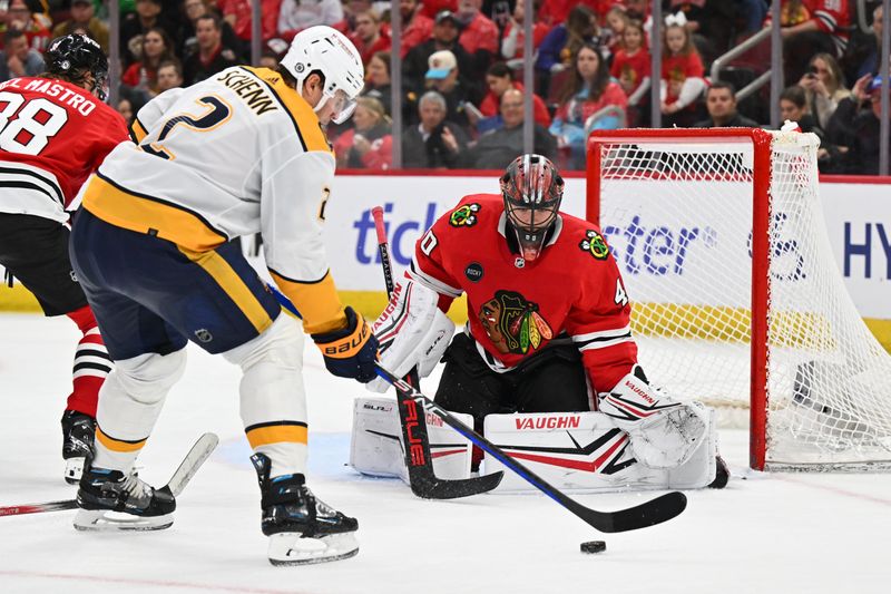 Apr 12, 2024; Chicago, Illinois, USA; Chicago Blackhawks goaltender Arvid Soderblom (40) tracks the puck as Nashville Predators defenseman Luke Schenn (2) moves in for a shot in the third period at United Center. Mandatory Credit: Jamie Sabau-USA TODAY Sports