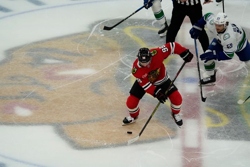 Oct 22, 2024; Chicago, Illinois, USA; Vancouver Canucks center Teddy Blueger (53) defends Chicago Blackhawks center Connor Bedard (98) during the second period at United Center. Mandatory Credit: David Banks-Imagn Images