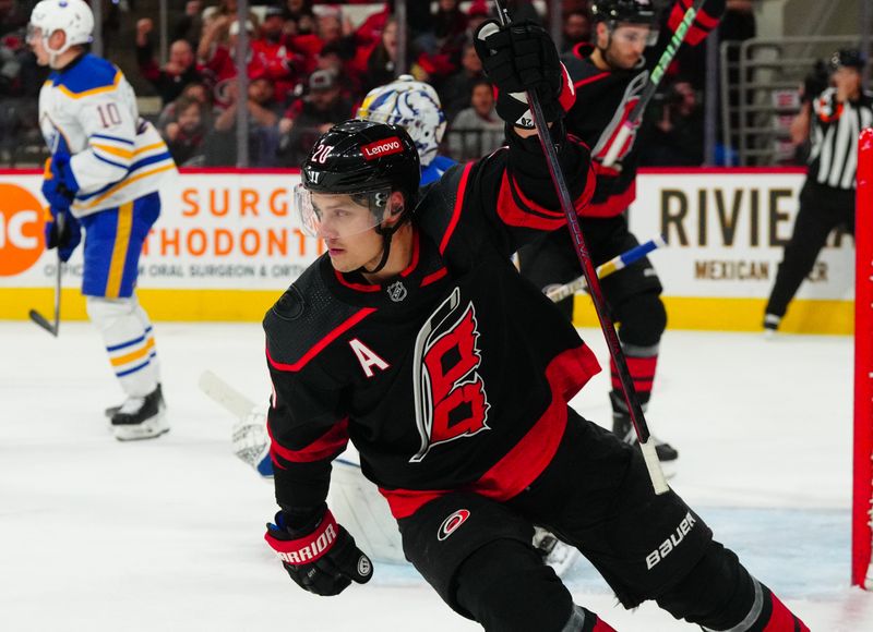 Dec 2, 2023; Raleigh, North Carolina, USA; Carolina Hurricanes center Sebastian Aho (20) scores a goal against the Buffalo Sabres during the first period at PNC Arena. Mandatory Credit: James Guillory-USA TODAY Sports