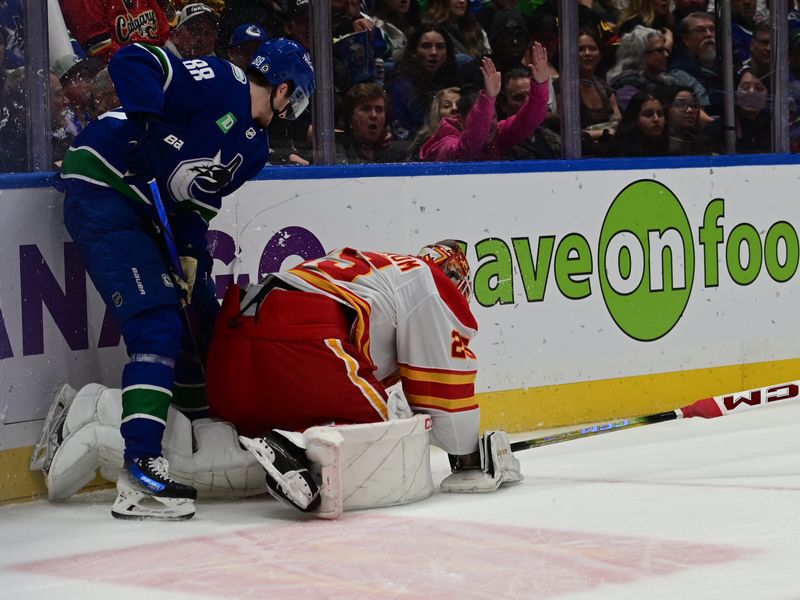 Mar 23, 2024; Vancouver, British Columbia, CAN; Vancouver Canucks forward Nils Aman (88) checks Calgary Flames goaltender Jacob Markstrom (25) during the first period at Rogers Arena. Mandatory Credit: Simon Fearn-USA TODAY Sports