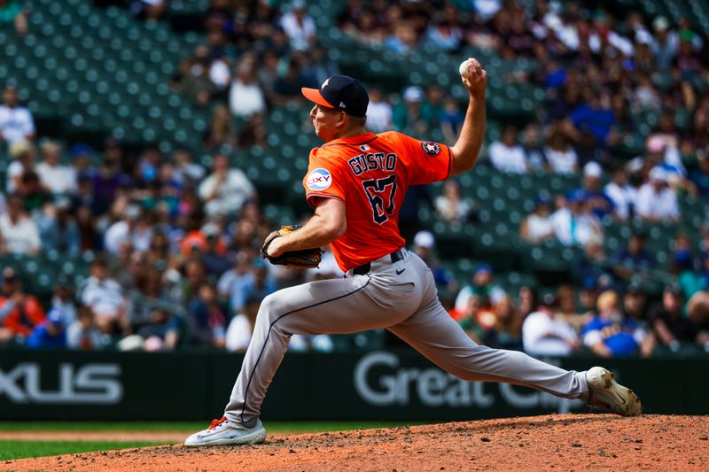 Jul 20, 2025; Seattle, Washington, USA; Houston Astros pitcher Ryan Gusto (67) throws against the Seattle Mariners during the ninth inning at T-Mobile Park. Mandatory Credit: Joe Nicholson-Imagn Images