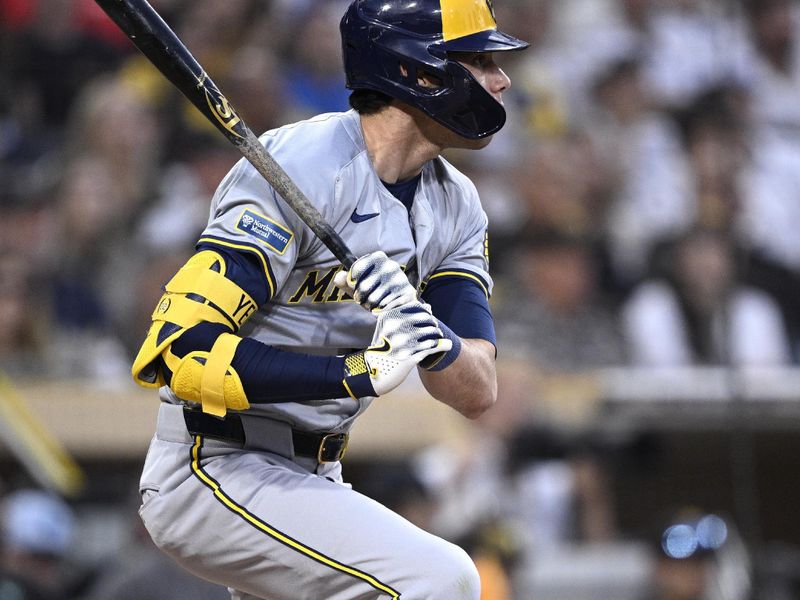 Jun 20, 2024; San Diego, California, USA; Milwaukee Brewers left fielder Christian Yelich (22) hits a single against the San Diego Padres during the fifth inning at Petco Park. Mandatory Credit: Orlando Ramirez-USA TODAY Sports