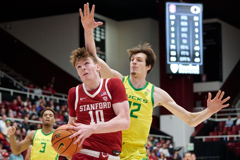 Jan 21, 2023; Stanford, California, USA; Stanford Cardinal forward Max Murrell (10) controls the ball against Oregon Ducks center Nate Bittle (32) during the first half at Maples Pavilion. Mandatory Credit: Robert Edwards-USA TODAY Sports