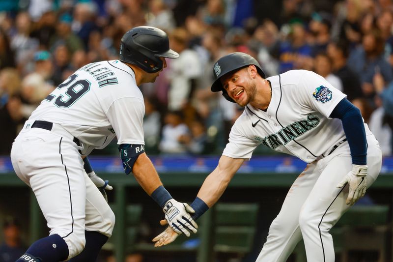 Jun 13, 2023; Seattle, Washington, USA; Seattle Mariners catcher Cal Raleigh (29) celebrates with left fielder Jarred Kelenic (10) after hitting a three-run home run against the Miami Marlins during the second inning at T-Mobile Park. Kelenic scored a run on the hit. Mandatory Credit: Joe Nicholson-USA TODAY Sports