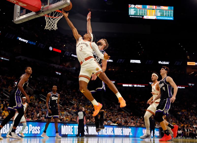 SAN ANTONIO, TX - NOVEMBER 17: Keldon Johnson #3 of the San Antonio Spurs goes to the basket past Domantas Sabonis #10 of the Sacramento Kings in the first half of an NBA In-Season Tournament game at Frost Bank Center on November 17, 2023 in San Antonio, Texas. NOTE TO USER: User expressly acknowledges and agrees that, by downloading and or using this photograph, User is consenting to terms and conditions of the Getty Images License Agreement. (Photo by Ronald Cortes/Getty Images)