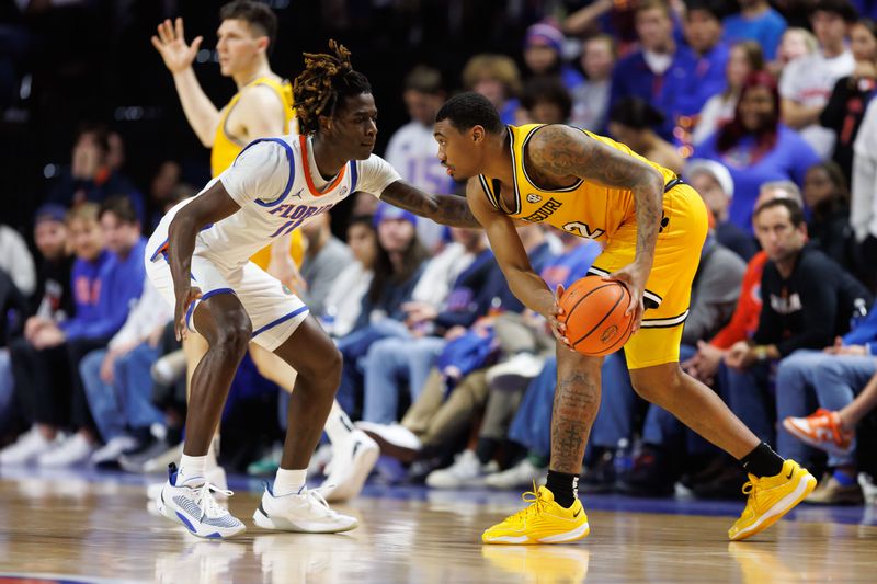 Jan 14, 2025; Gainesville, Florida, USA; Florida Gators guard Denzel Aberdeen (11) defends Missouri Tigers guard Tamar Bates (2) during the second half at Exactech Arena at the Stephen C. O'Connell Center. Mandatory Credit: Matt Pendleton-Imagn Images