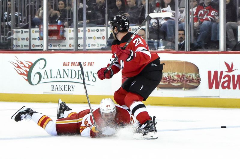 Feb 8, 2024; Newark, New Jersey, USA; Calgary Flames center Connor Zary (47) competes for the puck against New Jersey Devils right wing Timo Meier (28) during the second period at Prudential Center. Mandatory Credit: John Jones-USA TODAY Sports