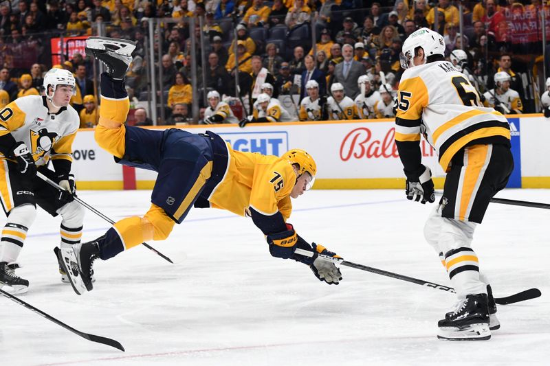 Nov 28, 2023; Nashville, Tennessee, USA; Nashville Predators center Juuso Parssinen (75) falls to the ice as he attempts a shot during the third period against the Pittsburgh Penguins at Bridgestone Arena. Mandatory Credit: Christopher Hanewinckel-USA TODAY Sports