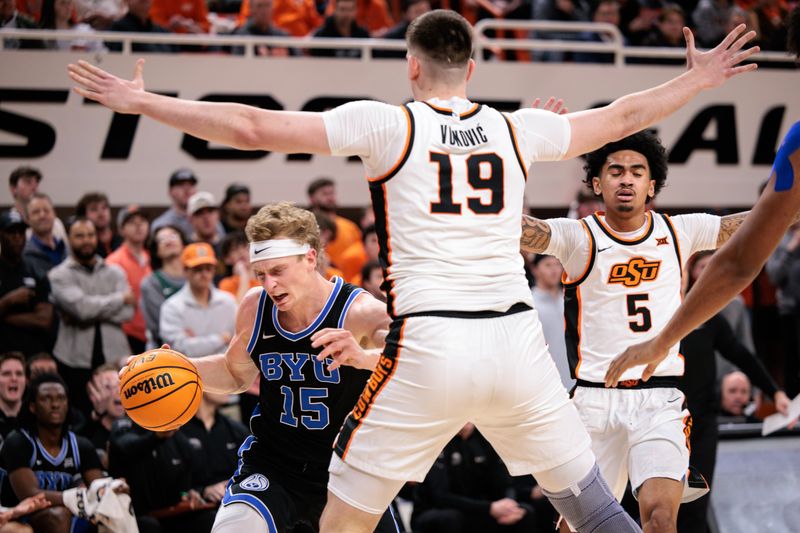 Feb 4, 2026; Stillwater, Oklahoma, USA; Oklahoma State Cowboys forward Andrija Vukovic (19) guards BYU Cougars guard Richie Saunders (15) during the second half at Gallagher-Iba Arena. Mandatory Credit: William Purnell-Imagn Images