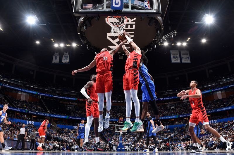 ORLANDO, FL - APRIL 1: Dalano Banton #5 and Jabari Walker #34 of the Portland Trail Blazers battle for a rebound with Jonathan Isaac #1 of the Orlando Magic on April 1, 2024 at Kia Center in Orlando, Florida. NOTE TO USER: User expressly acknowledges and agrees that, by downloading and or using this photograph, User is consenting to the terms and conditions of the Getty Images License Agreement. Mandatory Copyright Notice: Copyright 2024 NBAE (Photo by Fernando Medina/NBAE via Getty Images)