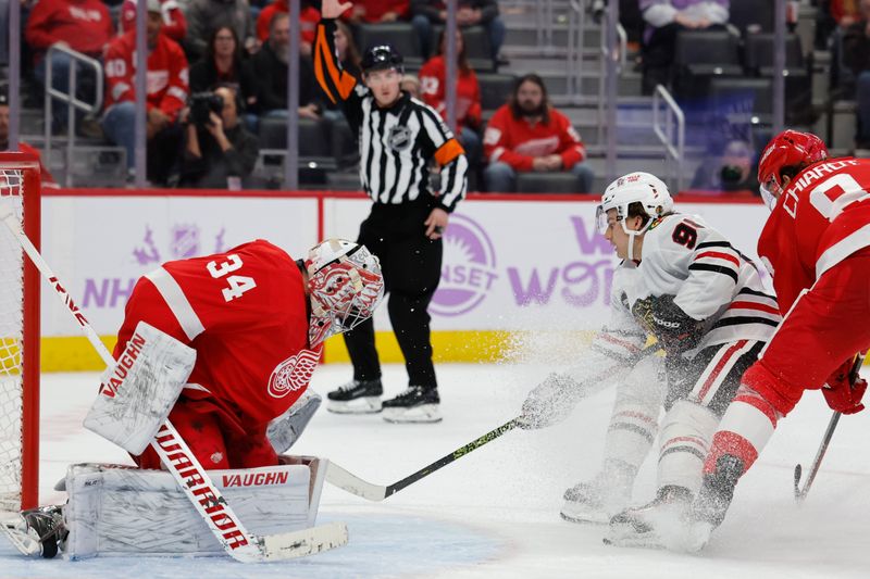 Nov 30, 2023; Detroit, Michigan, USA; Chicago Blackhawks center Connor Bedard (98) skates with the puck defended by Detroit Red Wings defenseman Ben Chiarot (8) in the third period at Little Caesars Arena. Mandatory Credit: Rick Osentoski-USA TODAY Sports