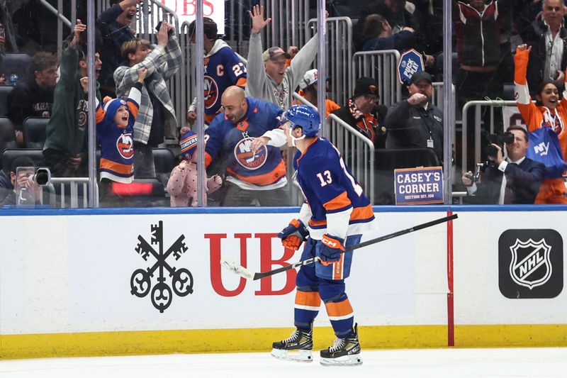 Oct 29, 2024; Elmont, New York, USA;  New York Islanders center Mathew Barzal (13) celebrates after scoring a goal in the third period against the Anaheim Ducks at UBS Arena. Mandatory Credit: Wendell Cruz-Imagn Images