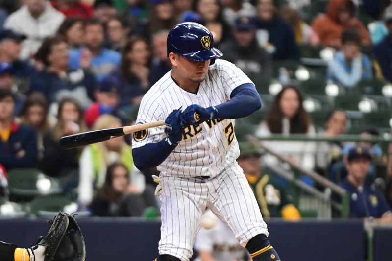 Jun 11, 2023; Milwaukee, Wisconsin, USA; Milwaukee Brewers third baseman Luis Ur  as (2) is hit by a pitch in the second inning against the Oakland Athletes at American Family Field. Mandatory Credit: Benny Sieu-USA TODAY Sports