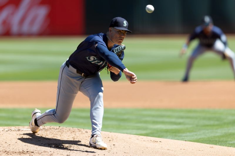 Sep 5, 2024; Oakland, California, USA; Seattle Mariners starting pitcher Bryan Woo (22) delivers a pitch against the Oakland Athletics during the first inning at Oakland-Alameda County Coliseum. Mandatory Credit: D. Ross Cameron-Imagn Images