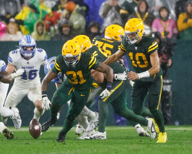 Green Bay Packers running back Emanuel Wilson (31) chases down a fumble but recovers against Detroit Lions during a NFL game Sunday, Nov. 3, 2024, in Green Bay, Wis. (AP Photo/Jeffrey Phelps