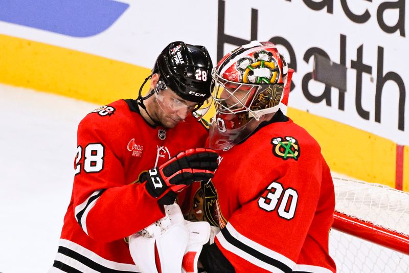 Jan 7, 2026; Chicago, Illinois, USA;  Chicago Blackhawks left wing Andre Burakovsky (28) fist bumps  goaltender Spencer Knight (30) after the game against the St. Louis Blues  at the United Center. Mandatory Credit: Matt Marton-Imagn Images