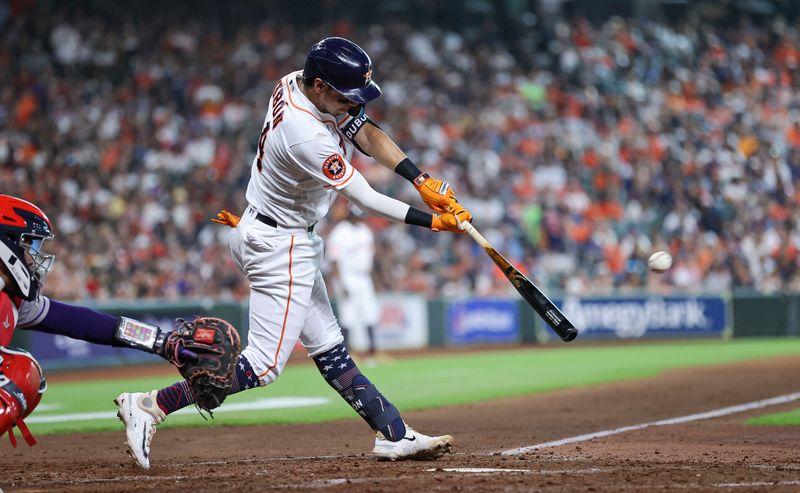 Jul 4, 2023; Houston, Texas, USA; Houston Astros second baseman Mauricio Dubon (14) hits an RBI triple during the fifth inning against the Colorado Rockies at Minute Maid Park. Mandatory Credit: Troy Taormina-USA TODAY Sports