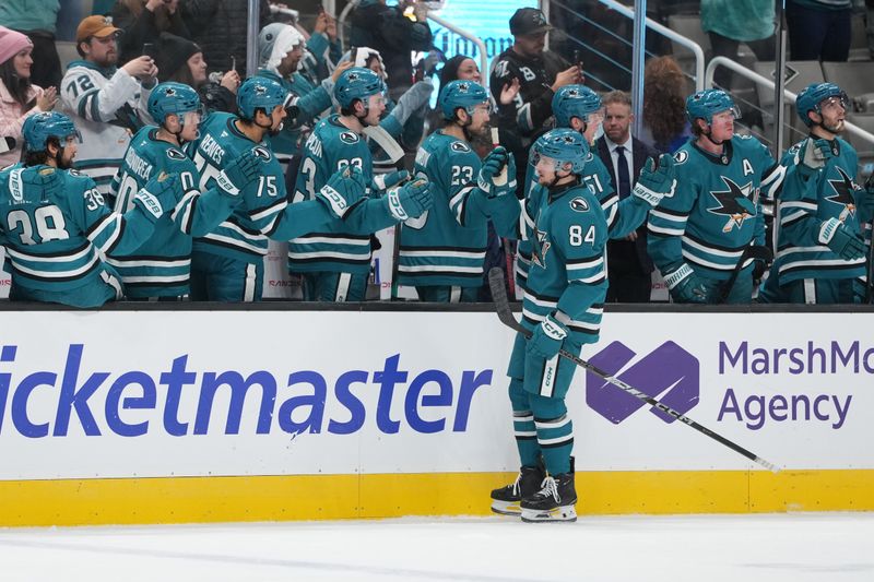 Jan 3, 2026; San Jose, California, USA; San Jose Sharks left wing Pavol Regenda (84) is congratulated by teammates after scoring a goal against the Tampa Bay Lightning during the first period at SAP Center at San Jose. Mandatory Credit: Darren Yamashita-Imagn Images