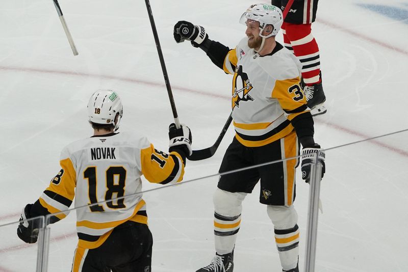 Dec 28, 2025; Chicago, Illinois, USA; Pittsburgh Penguins right wing Anthony Mantha (39) celebrates his goal with center Tommy Novak (18) against the Chicago Blackhawks during the first period at United Center. Mandatory Credit: David Banks-Imagn Images