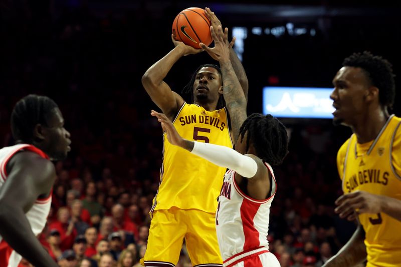 Feb 17, 2024; Tucson, Arizona, USA; Arizona State Sun Devils guard Jamiya Neal (5) shoots a basket agaisnt Arizona Wildcats guard Caleb Love (2) during the first half at McKale Center. Mandatory Credit: Zachary BonDurant-USA TODAY Sports